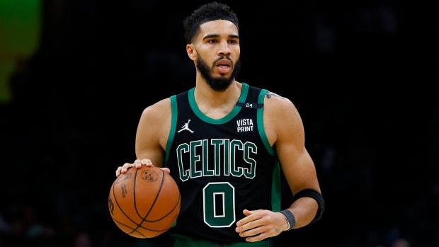 Boston Celtics forward Jayson Tatum (0) brings the ball up the court against the Minnesota Timberwolves.